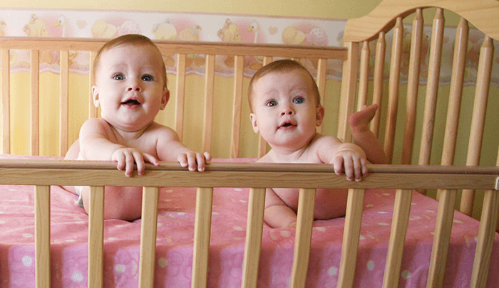 newborn twins in same crib